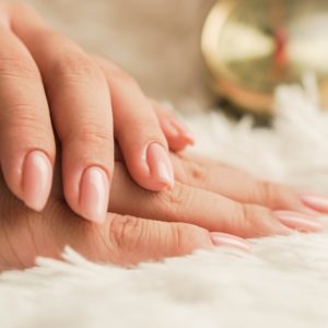 persons hand on white textile