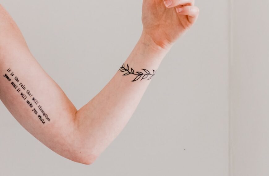 person showing arm and wrist tattoo