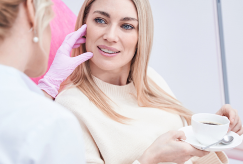 Beauty therapist discussing a facial treatment with a client during a consultation.