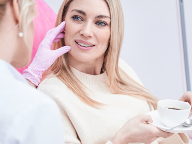 Beauty therapist discussing a facial treatment with a client during a consultation.