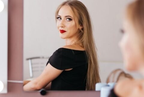 Woman looking at her reflection in a salon mirror.